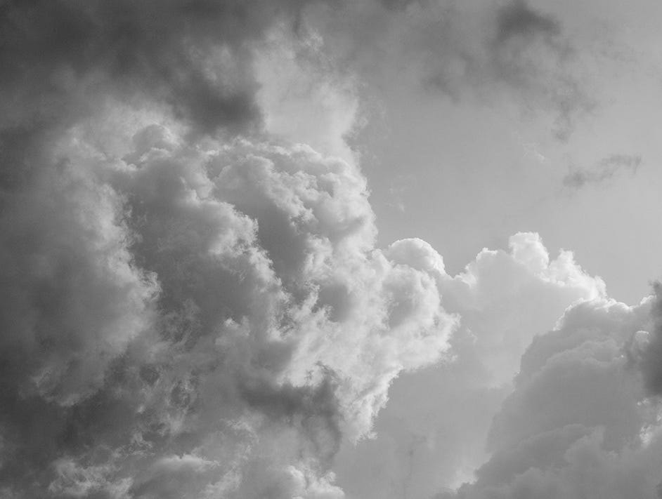 a black-and-white image of clouds in the sky. 