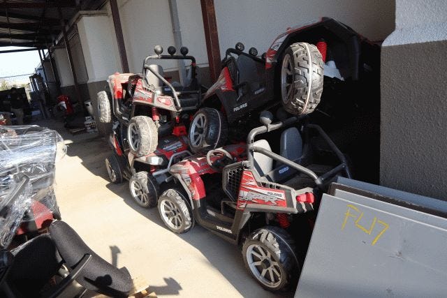 Four youth-sized ATVs stacked on top of each other