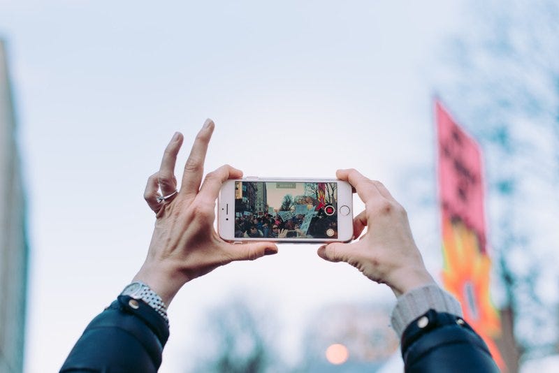 I took this photo at the Women’s March in Boston. I was shooting with my Nikon D750 with a 50mm prime lense which made catching the wider angles a bit tough. I looked up and could see the expanse of people through the screen of the persons phone above me and I had to grab it! Very Meta :)