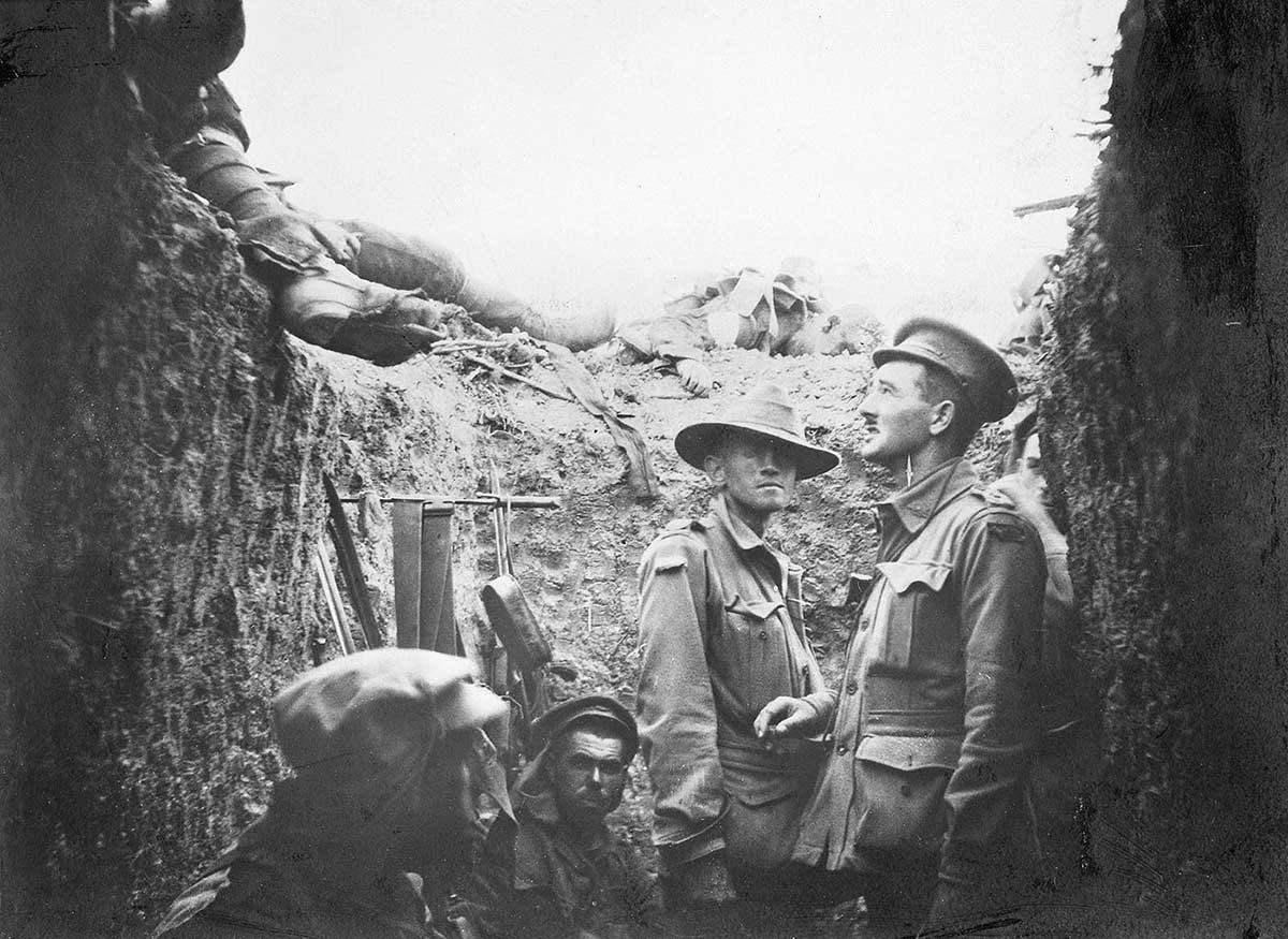 Black and white photo showing Australian soldiers in a trench.