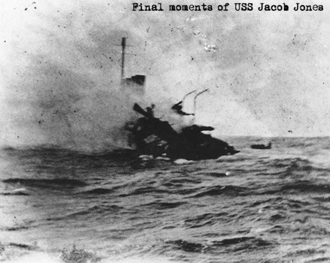 A grainy black and white photo shows the final moments of USS Jacob Jones.