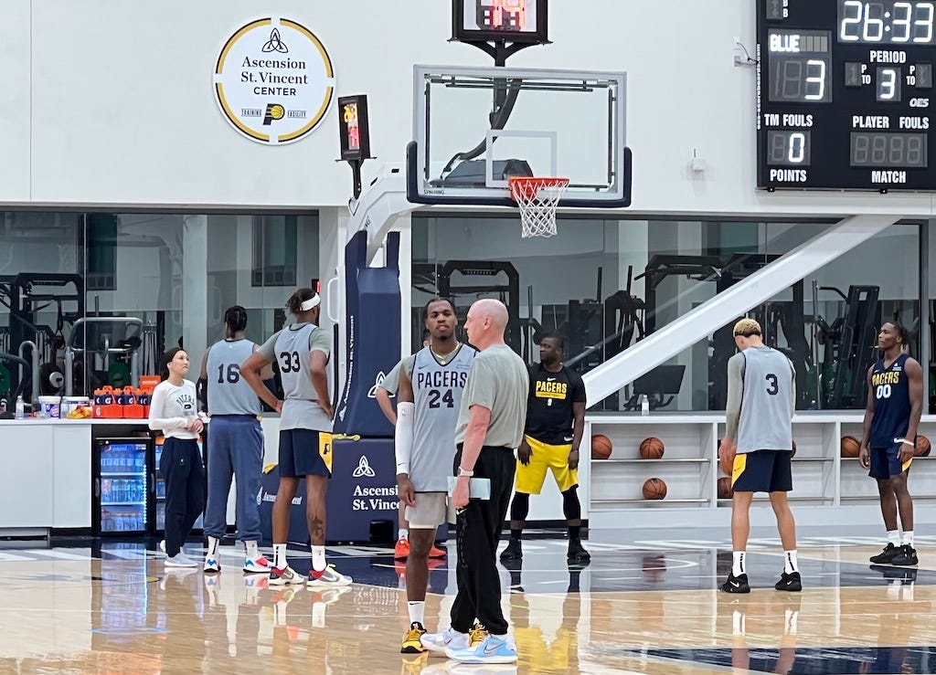Buddy Hield talks with coach Rick Carlisle after Pacers practice.