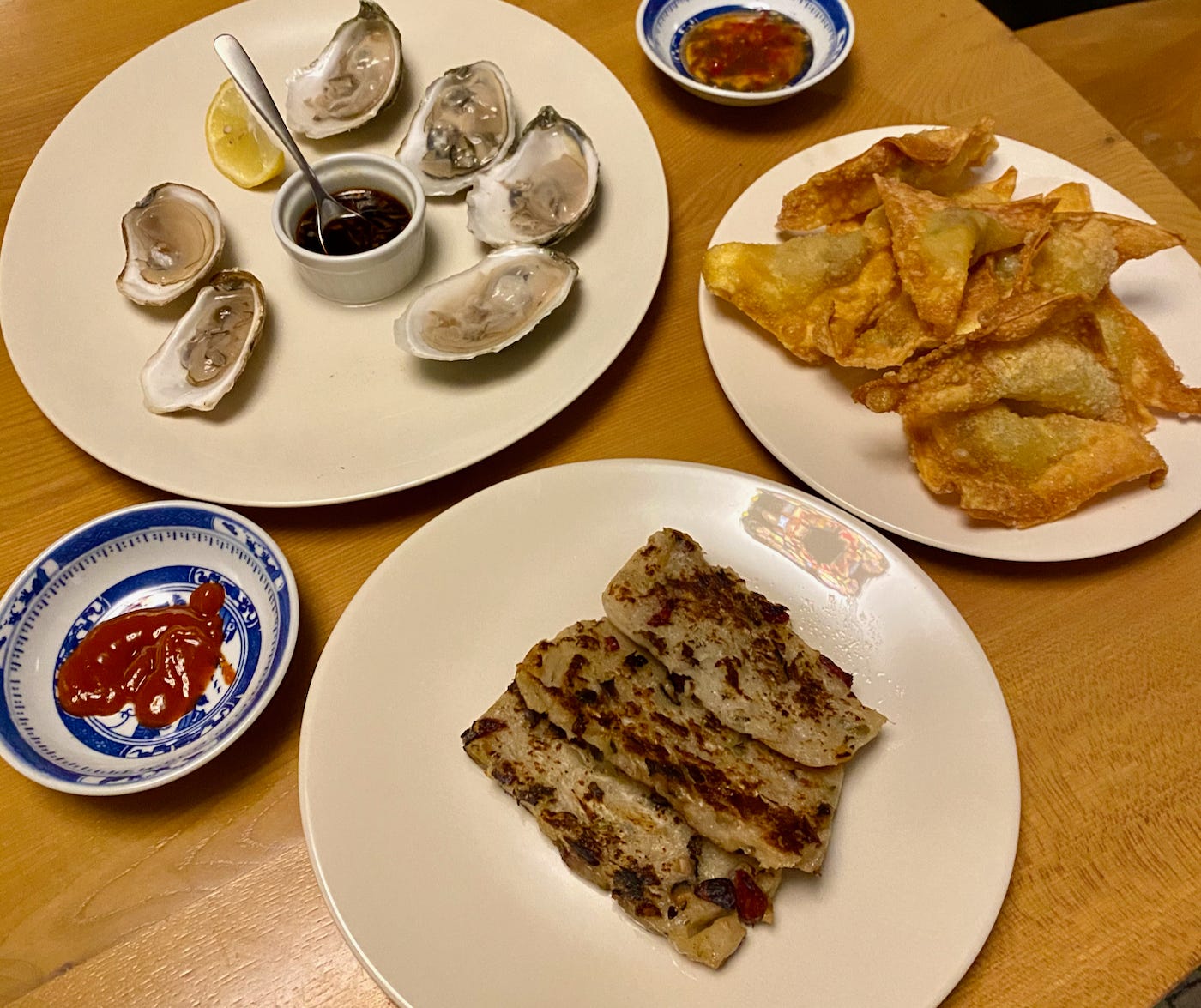 Chinese New Year appetizers: oysters, fried wonton, daikon cakes