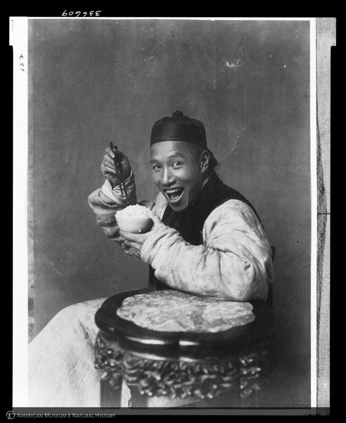 A picture from 1904 â yes, 1904 â of a man smiling while eating rice. (Laufer/AMNH)