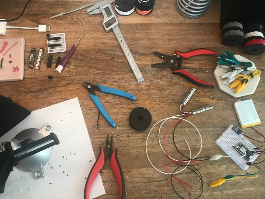 A top down view of various tools including pliers, wires, and more that Charlyn uses in her workshop.