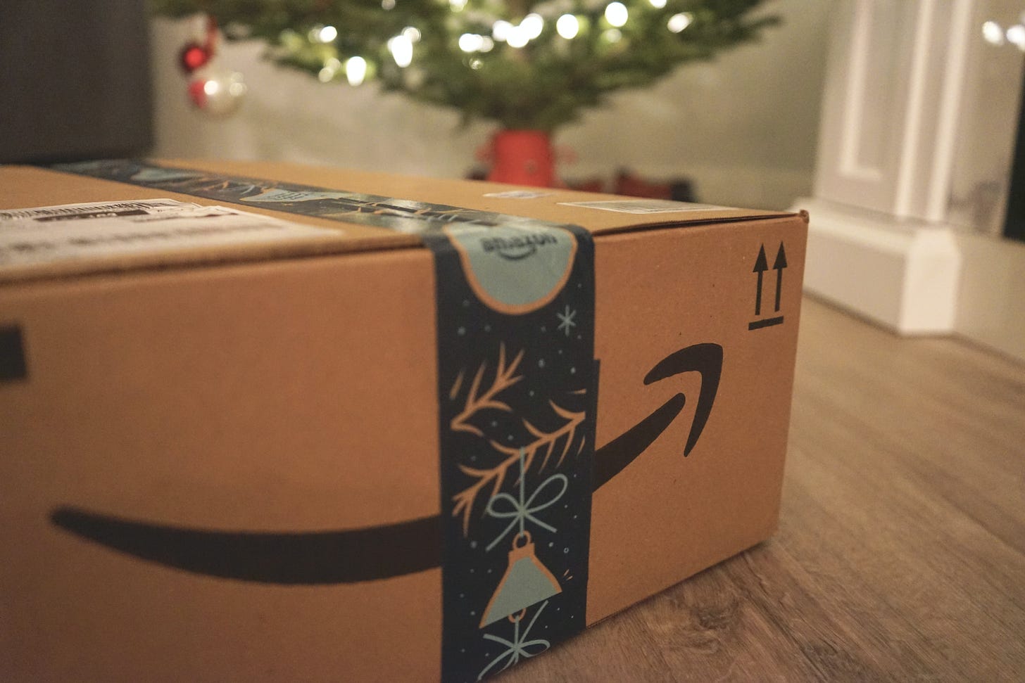 Photo of an Amazon box under a Christmas tree. Wicked Monday / Unsplash