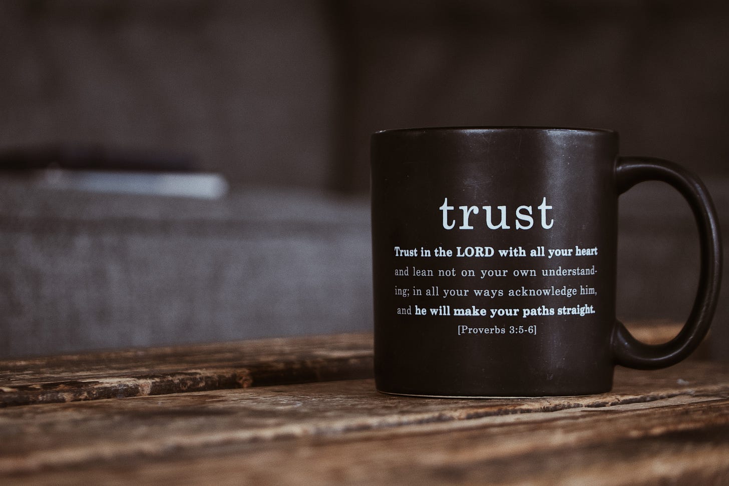 A coffee cup with Proverbs 3:5-6 printed on it. 