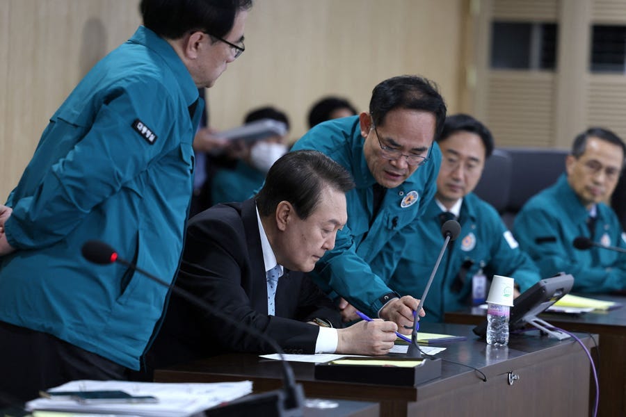 This handout photo taken and released on November 2, 2022 by the South Korean Presidential Office via Yonhap news agency shows South Korean President Yoon Suk-yeol (C) speaking at a meeting of the National Security Council over North Korea's missile launch, at the presidential office in Seoul. North Korea fired at least 10 missiles on November 2, including one that landed close to South Korea's territorial waters and prompted a rare warning for people on an island to shelter in bunkers.