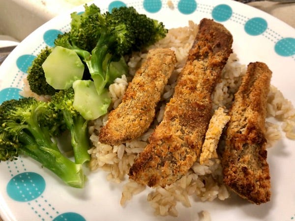 brown rice, broccoli, and plant squad tenders on a plate.