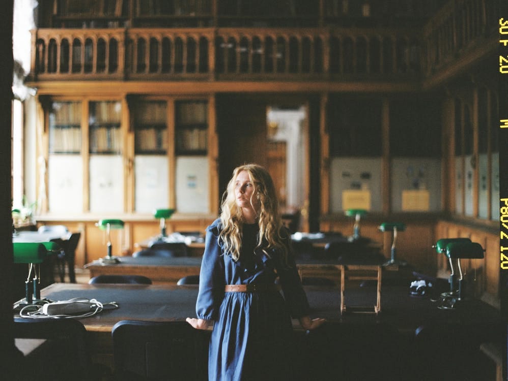 Free Woman in Blue Dress in a Library Stock Photo