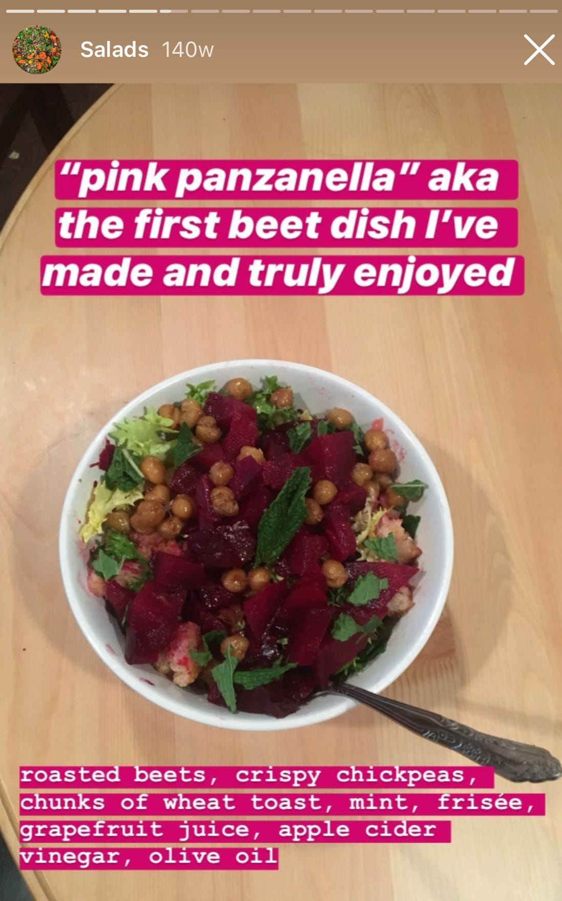 bowl of beet salad with caption "pink panzanella, aka the first beet dish i've made and truly enjoyed. roasted beets, crispy chickpeas, chunks of wheat toast, mint, frisee, grapefruit juice, apple cider vinegar, olive oil"