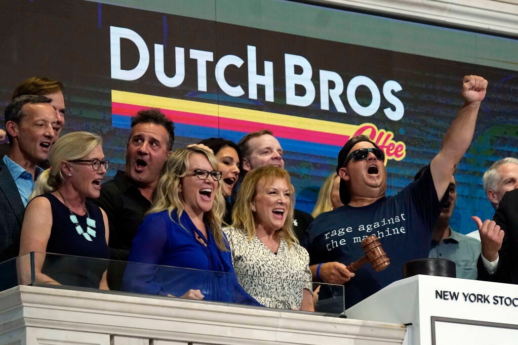 Dutch Bros Coffee Co-founder and Executive Chairman Travis Boersma, right, leads a chant before ringing the New York Stock Exchange closing bell, Wednesday, Sept. 15, 2021. (AP Photo/Richard Drew)