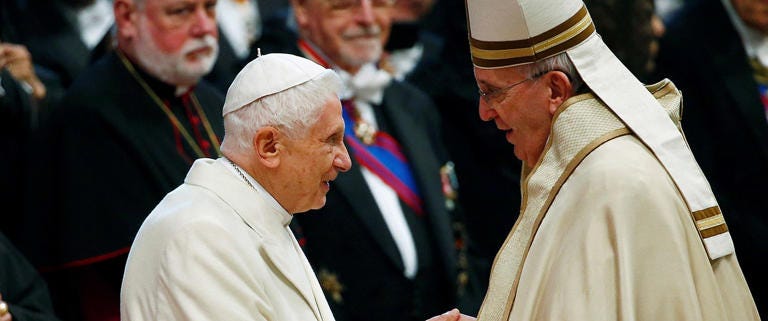 FILE PHOTO: Pope Francis greets Pope Emeritus Benedict XVI during a mass to create 20 new cardinals during a ceremony in St. Peter's Basilica at the Vatican Feb. 14, 2015. REUTERS/Tony Gentile/File Photo