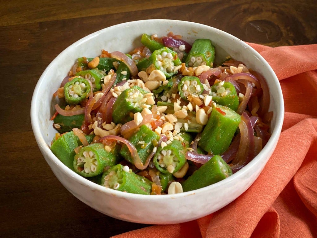 A bowl of okra sautéd with red onion, garlic, peanuts and tomato, prepared from a recipe by chef Marcus Samuelsson