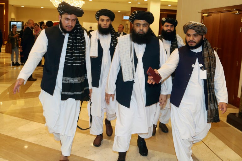 A few members of the Taliban delegation head to attend the opening session of the peace talks between the Afghan government and the Taliban in Doha on September 12, 2020 [File: AP/Hussein Sayed]