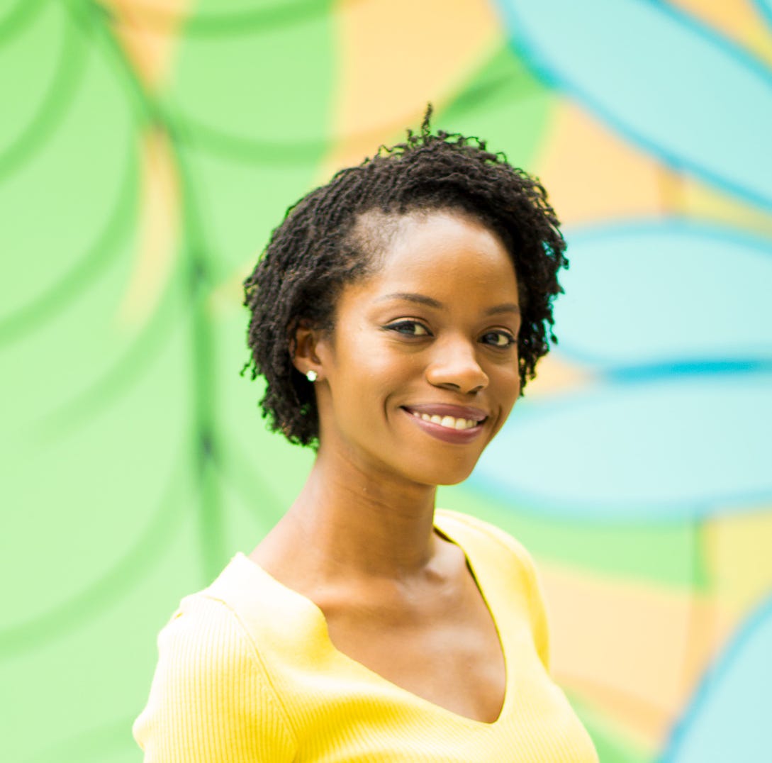 A photo of the author against a green, yellow, and blue background