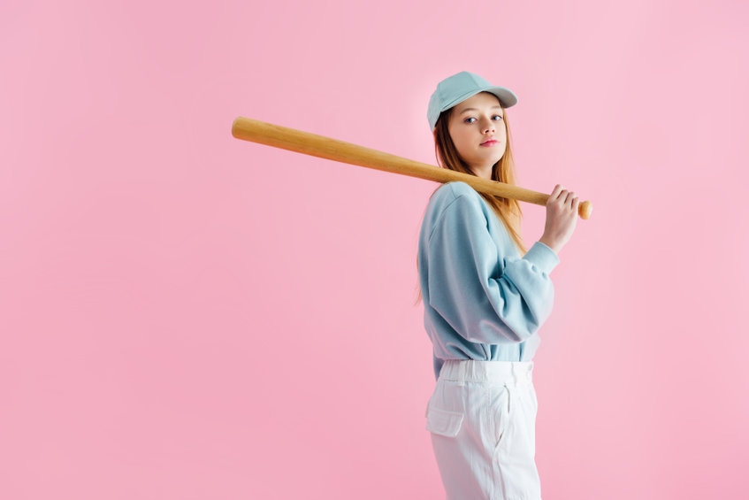 Teenage girl holding a baseball bat