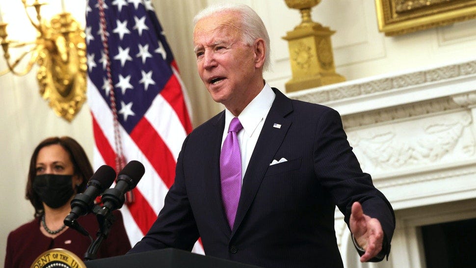 WASHINGTON, DC - JANUARY 21: U.S. President Joe Biden speaks as Vice President Kamala Harris looks on during an event at the State Dining Room of the White House January 21, 2021 in Washington, DC. President Biden delivered remarks on his administration’s COVID-19 response, and signed executive orders and other presidential actions.