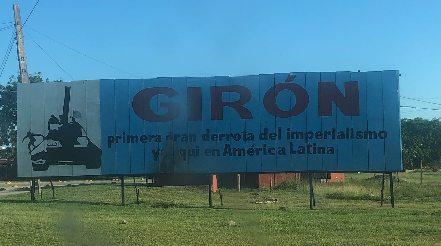 A giant sign for Giron village, showing a stencil of a tank