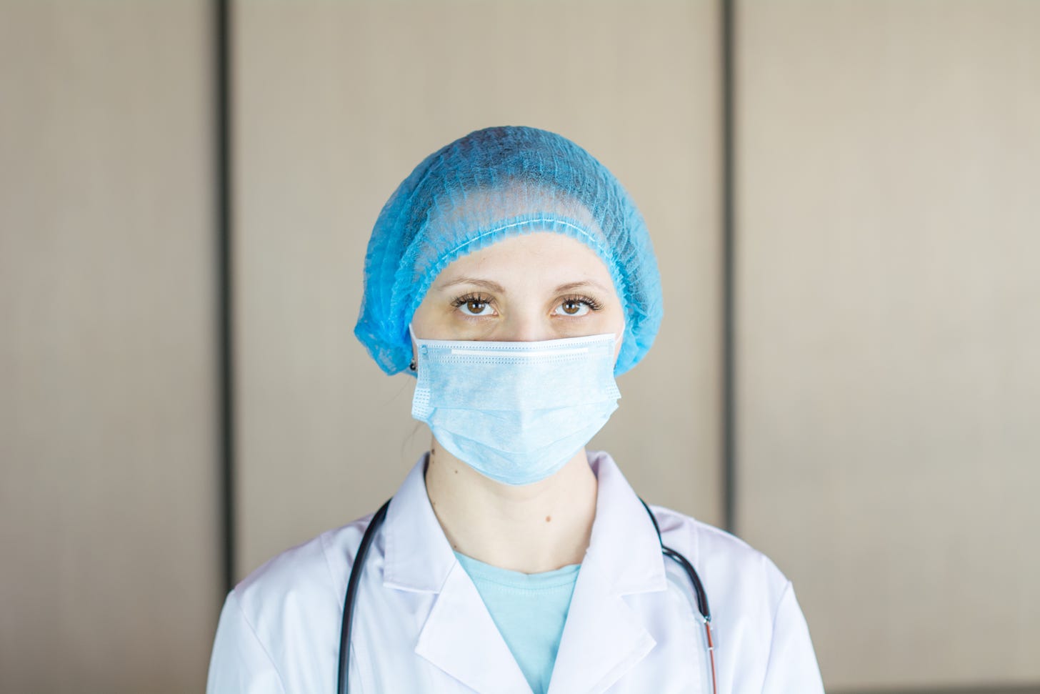 woman doctor in scrubs staring at camera