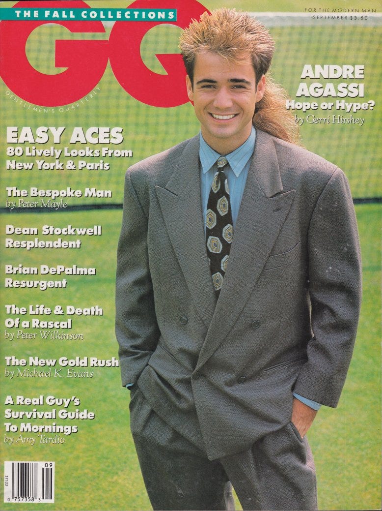 Andre Agassi standing on a grass tennis court in a bad suit with worse hair. Cover of GQ magazine September 1989