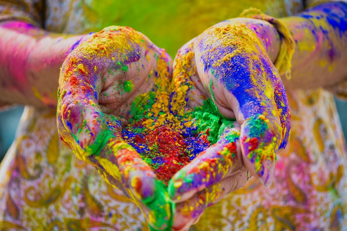 Person's Hand Full Of Colored Powder