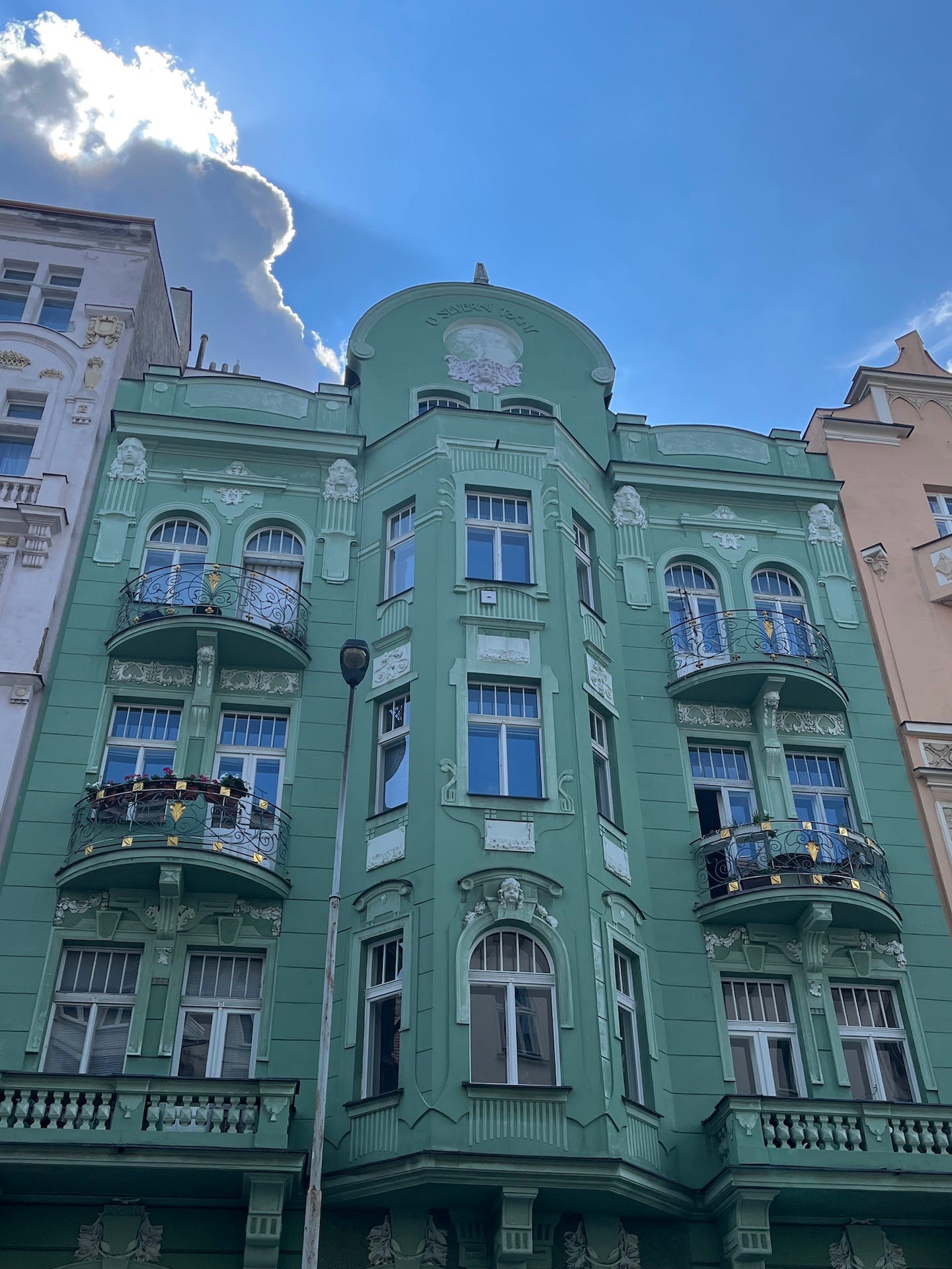 Green, ornate apartment building in Prague