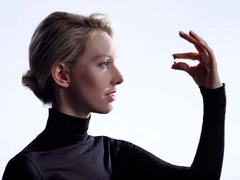 Elizabeth Holmes holding a pill promoting Theranos