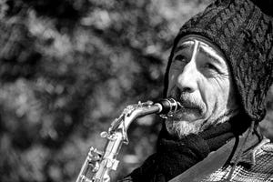 Mono close-up of bearded saxophonist in hat.jpg
