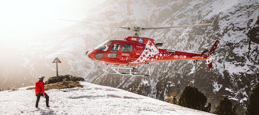 Rescue helicopter with man in the snow
