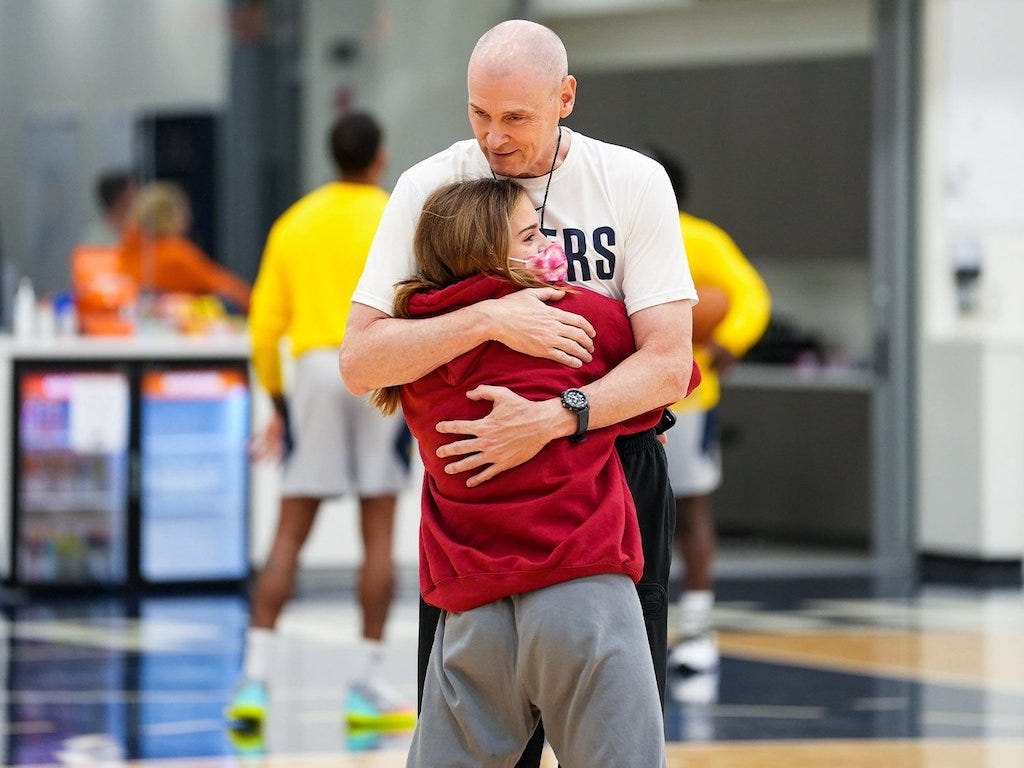 Abby Carlisle hugs dad after a Pacers practice she attended one year ago. (Photo: PS&E)