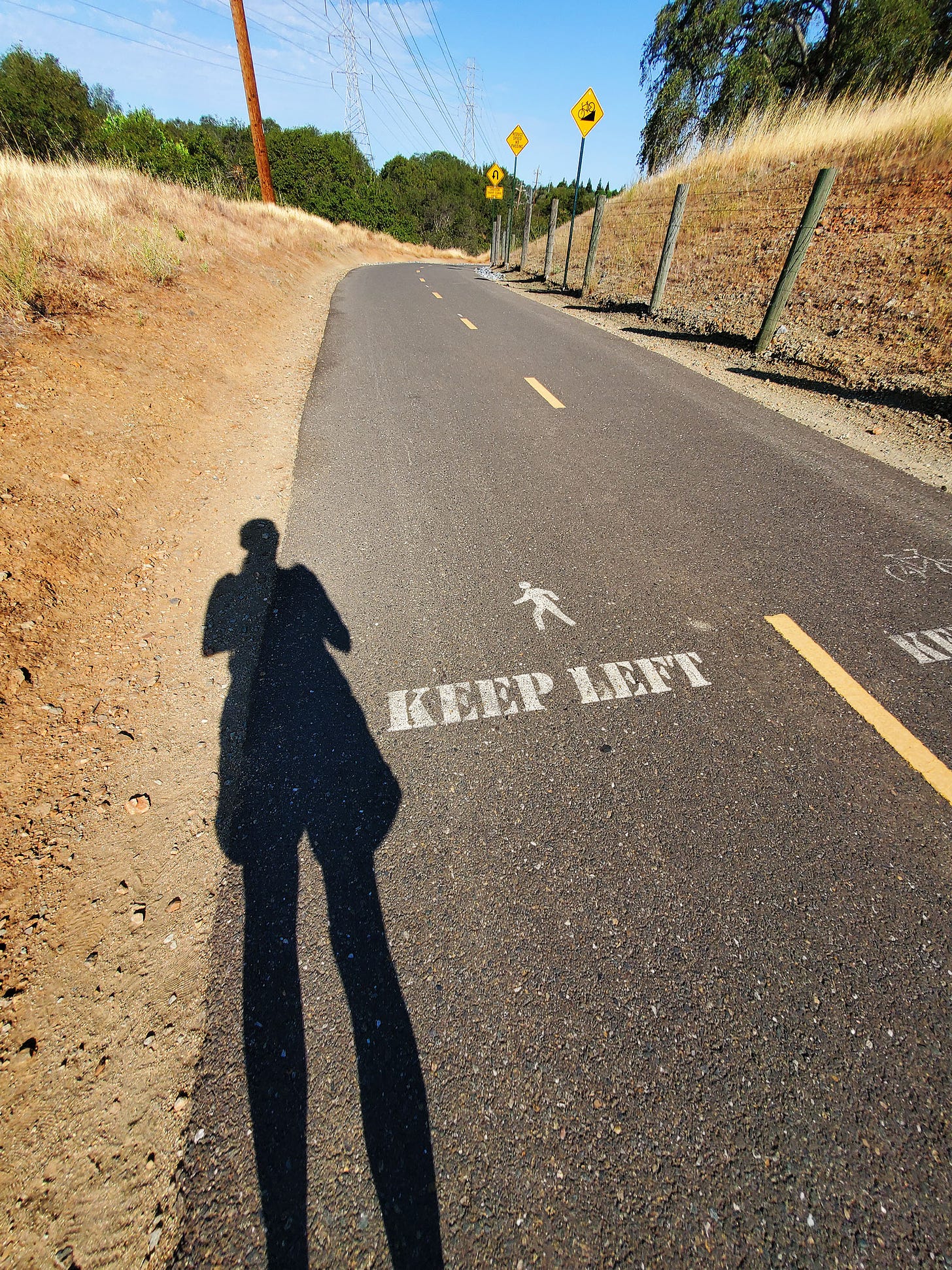 Shadow of woman on bike trail