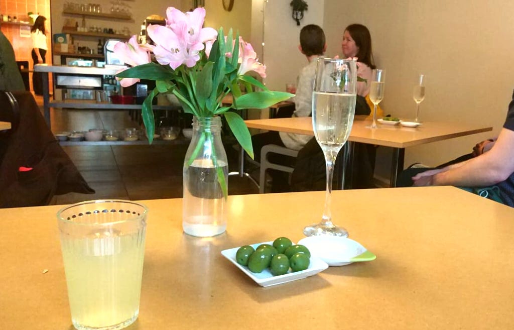 Students at a pasta making class enjoy glasses of processo, home-made lemonade and olives. 