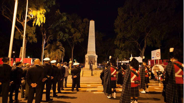 People standing in uniform at the war memorial in Parramatta.