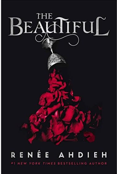 The cover of “The Beautiful” by Renee Ahdieh. The cover of the book is black with the title written in bold, silver letters at the top of the page. Below the title, a silver goblet is spilling over and crimson rose petals are spilling out into a pile on the floor. 