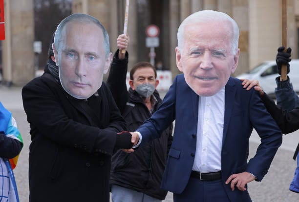 Protesters dressed as Russian President Vladimir Putin and U.S. President Joe Biden attend a small rally to demand a diplomatic solution to the...
