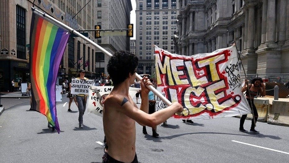 Protesters camped outside City Hall march in the street after a decision about ICE was made, Friday July 27, 2018, in Philadelphia. Mayor Jim Kenney announced Friday that Philadelphia will stop giving U.S. Immigration and Customs Enforcement (ICE) access to a real-time arrest database.