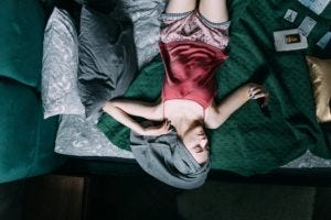 woman in head towel lying in bed
