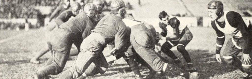 Schoch, Akron's QB, takes the snap and prepares to pass against Ashland in 1924. 