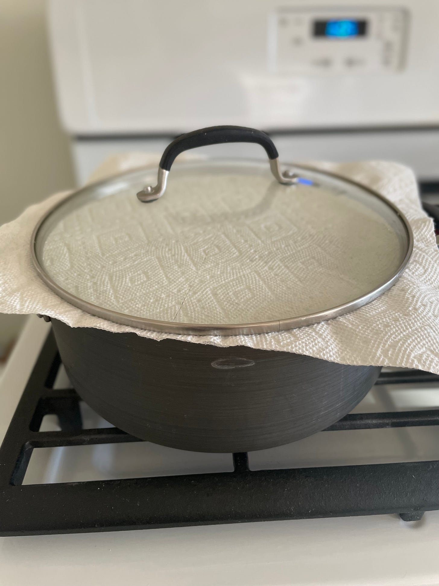 Pot of rice with paper towel on top for steaming