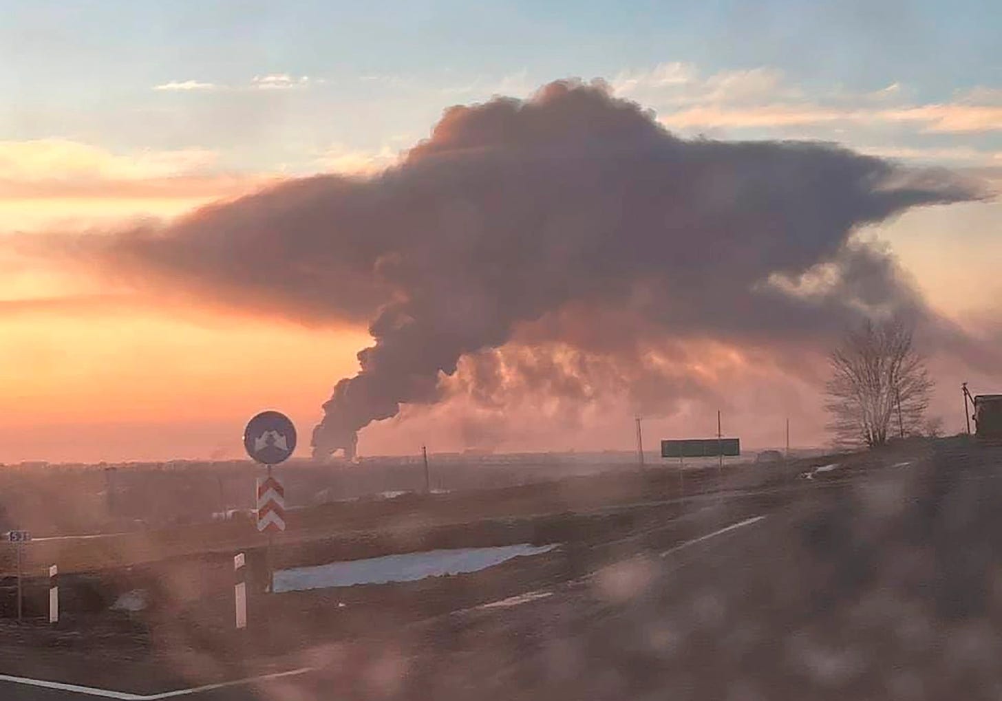 Dawn broke on a besieged Ukraine - picture shows Chuhuiv military airfield in Kharkiv outskirts burning after a Russian strike