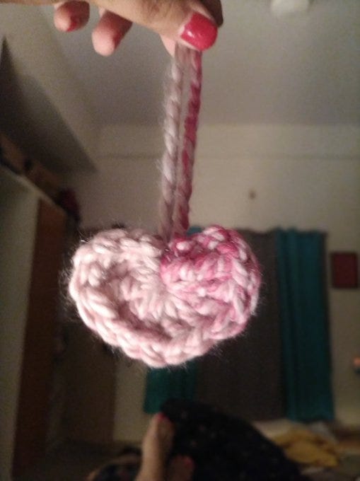 A heart shaped ornament done in crochet