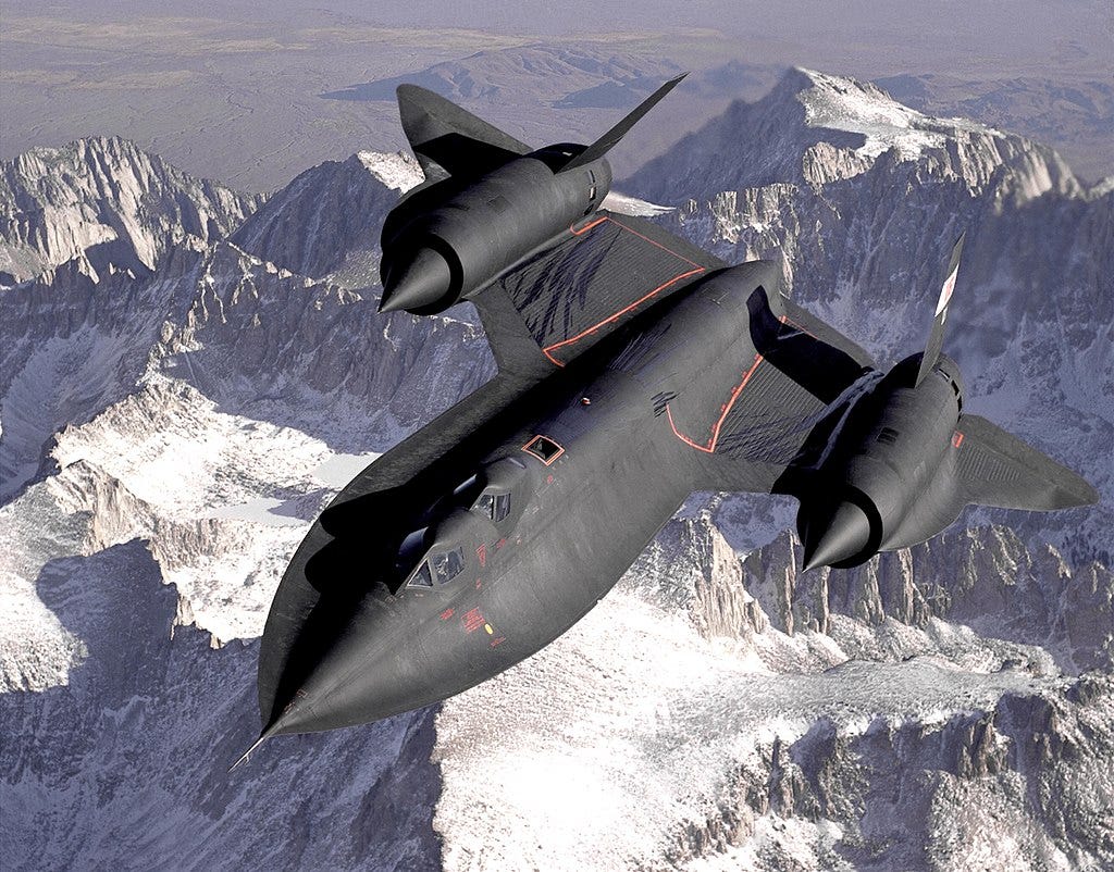 Dryden's SR-71B Blackbird, NASA 831, slices across the snow-covered southern Sierra Nevada Mountains of California after being refueled by a USAF tanker during a 1994 flight. SR-71B was the trainer version of the SR-71. The dual cockpit allows the instructor to fly.