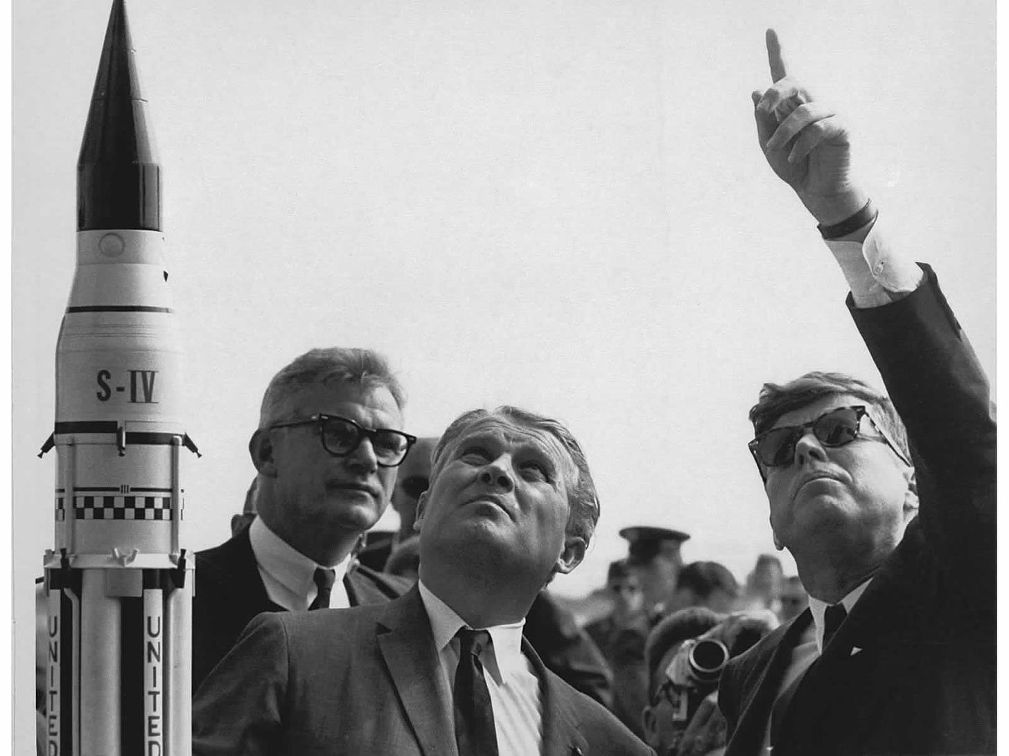 Photograph of JFK pointing skyward