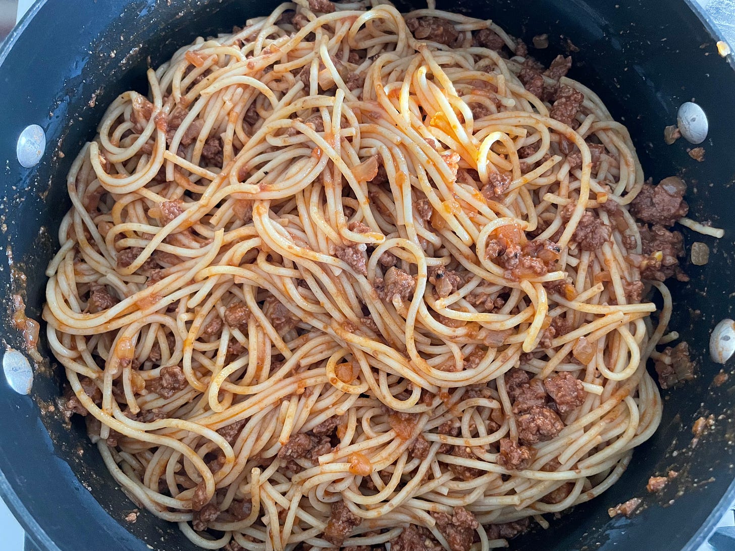 spaghetti noodles mixed with meat sauce