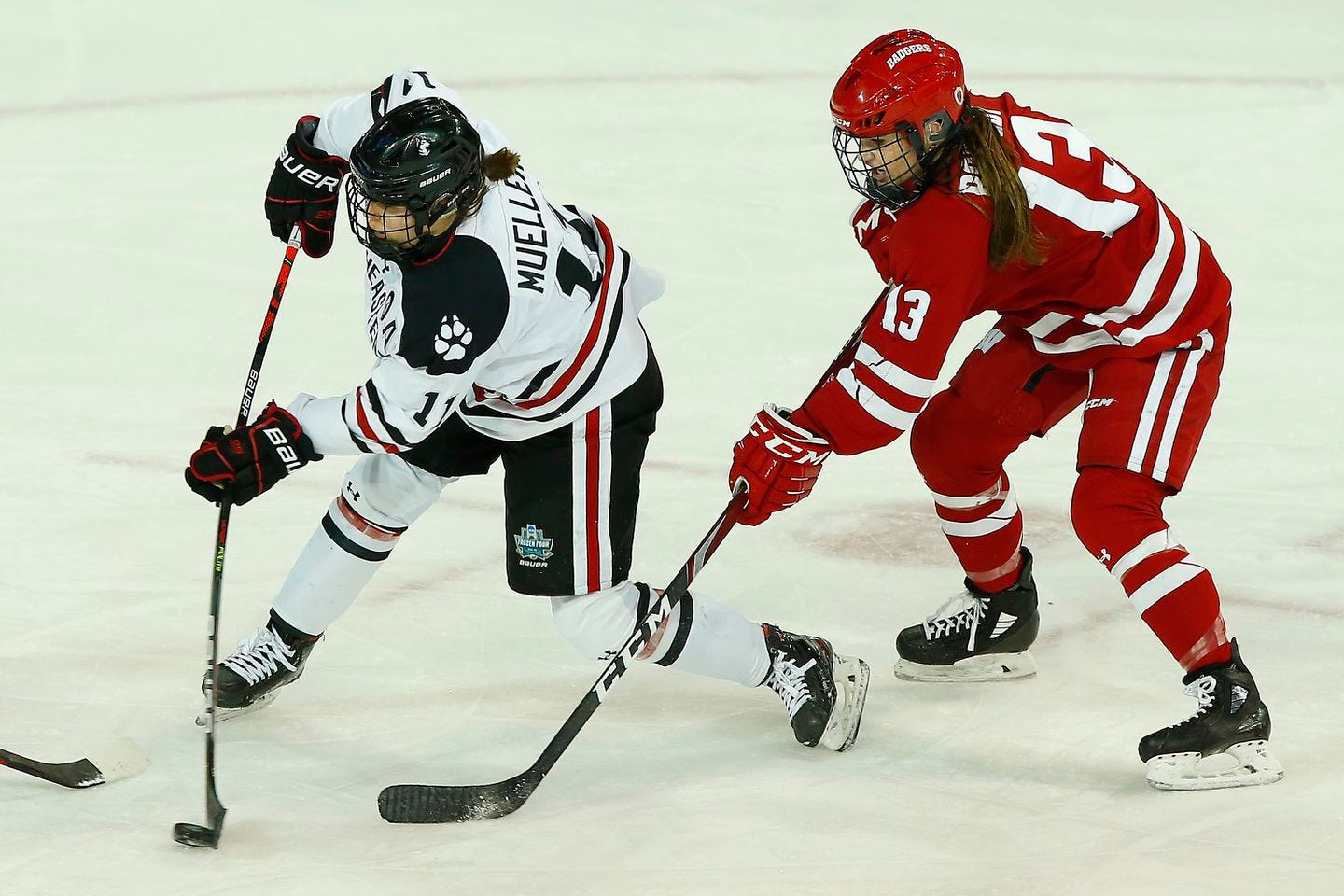 Northeastern's Alina Mueller takes a shot in front of Wisconsin's Grace Bowlby in the women's Frozen Four NCAA championship game in Erie, Pa.