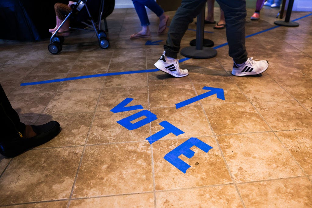 People head to the voting booths to cast their in-person absentee ballots at Seacoast Church West Ashley on October 30 in Charleston, South Carolina. (Michael Ciaglo / Getty Images)