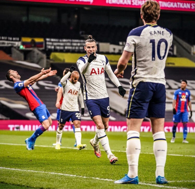 Gareth Bale points at Harry Kane in delight while a Crystal Palace defender appears to be in agony
