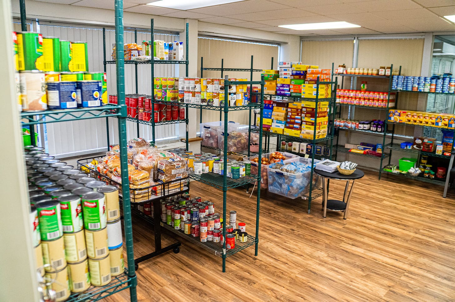 packages and containers of various food products are placed on the shelves of tall racks. 