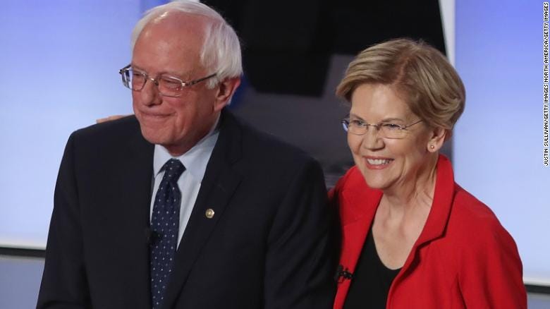 Democratic presidential candidates Sen. Bernie Sanders (I-VT) and Sen. Elizabeth Warren (D-MA) take the stage at the beginning of the Democratic Presidential Debate at the Fox Theatre July 30, 2019 in Detroit, Michigan. (Photo by Justin Sullivan/Getty Images)